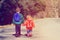 Kids go to school - brother and sister with backpacks walking on the road