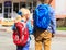 Kids go to school- little boy and girl with backpacks on street