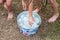 Kids grabbing water balloons from metal bucket