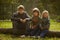 Kids in green forest playing,concept of children vacations and travel, boys siting on tree