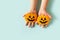 Kids halloween handmade paper pumpkins with childrens hands