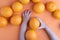 Kids hands holding appetizing fresh oranges, view above