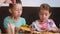 Kids having fun eating pizza in a cafe