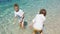 Kids having fun in water outdoors. Happy Children joyful little boy and girl playing in shallow Water. Summer fun