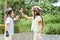 Kids in helmets high-fiving in park