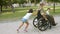 Kids helping disabled military dad to wheel heavy wheelchair