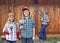 Kids helping their mother painting the wood shed