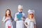 Kids imagine future profession. Cute little doctors on grey background.