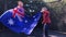 Kids jumping with Australia flag on trampoline.