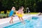 Kids jumping into swimming pool