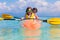 Kids kayaking in ocean. Family in kayak in tropical sea