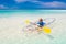 Kids kayaking in ocean. Family in kayak in tropical sea