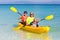 Kids kayaking in ocean. Family in kayak in tropical sea