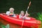 Kids kayaking in summer sport camp