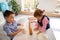 Kids in the kitchen playing with white flour