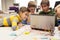 Kids, laptop and invention kit at robotics school