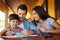 Kids learn better with love. Shot of a couple and their son coloring in together outdoors.