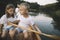 Kids learning to paddle canoe with father