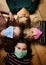 Kids lie in colorful masks during the coronavirus pandemic