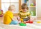 Kids little boy plays with a multi colored puzzle in nursery