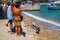 Kids look the friendly seal laying at Patitiri beach in Alonnisos island, Sporades, Greece