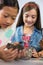 Kids looking at specimen stone through magnifying glass