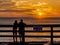 Kids looking at sunrise from the pier