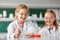 Kids making chemical experiment at school lab