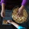 Kids making Kek Batik or Malaysian Triple Chocolate Dessert. Doing the initial steps, crushing the cookies into tiny pieces