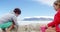 Kids making making sand castle at beach