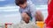 Kids making making sand castle at beach
