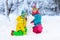 Kids making winter snowman. Children play in snow