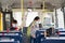 Kids with medical mask coming inside school bus and sitting on seats while maintaining social distance due to coronavirus or covid