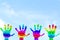 Kids Painted Hand art colorful rainbow hand prints in sky background