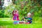 Kids picking cherry on a fruit farm garden