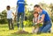 Kids planting trees with volunteer