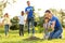 Kids planting trees with volunteers