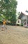 Kids play bikes in front of the house, cheery