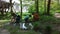 Kids play in a puddle in the nature playground in the park on a sunny spring day