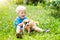 Kids play with puppy. Children and dog in garden.