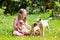 Kids play with puppy. Children and dog in garden