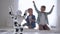 Kids play with robot at home, modern white toy engage sport and shows movements for boys