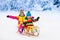 Kids play in snow. Winter sleigh ride for children