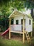 Kids Playhouse with red Slide. Vertical photo image.