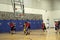 Kids playing basketball match