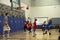 Kids playing basketball match