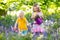 Kids playing in blooming garden with bluebell flowers