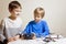 Kids playing with drone at home. One boy holding a radio remote control fo quadcopter.