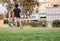 Kids playing footbal on green grass, in a home garden