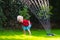 Kids playing with garden sprinkler